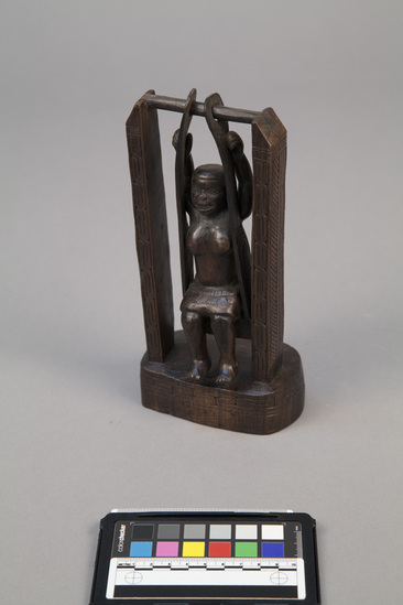 Hearst Museum object titled Wood human figure, woman on swing*, accession number 11-42026, no description available.