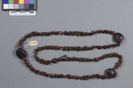 Hearst Museum object titled Necklace, accession number 11-39701, described as Made with brown seeds and scattered red seeds and three "goat's eyes.