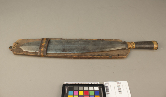 Hearst Museum object titled Knife and sheath, accession number 10-2242a,b, described as A) Sword-knife. Bands of rattan on hilt, 20¼ inches long B) Scabbard. open, wood; rattan band; rattan loop for hanging; 17⅛ inches long