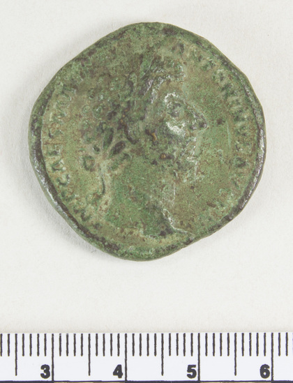 Hearst Museum object 7 of 8 titled Coin: æ sestertius, accession number 8-4022, described as Coin; AE; Sestertius; Roman. Marcus Aurelius, 161-162 AD. Rome, Italy Obverse: IMP CAES M AVREL ANTONINVS AVG P M, Bust r. laureate. Reverse: SALVTI AVGVSTOR TR P XVII, Salus left feeding snake at altar; S C in field; in exergue, COS III.