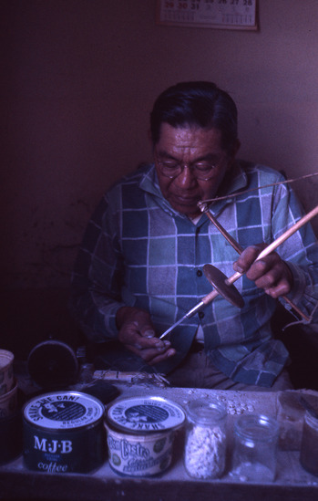Hearst Museum object titled Color slide, accession number 25-2046, described as Leonard Bateman, Pomo, making clamshell beads