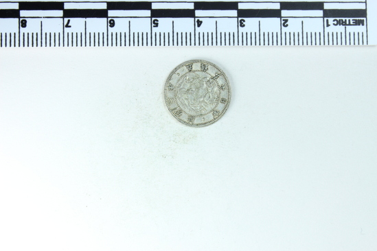 Hearst Museum object titled Coin, accession number 9-11889, described as Coin, silver, Japan.  Obverse: Wreath with bow and flower (chrysanthemum?) surrounding centered sun.  Reverse: Center stylized dragon, Japanese characters round edge.  Denomination: ? 5 Sen; 1.32 grams.