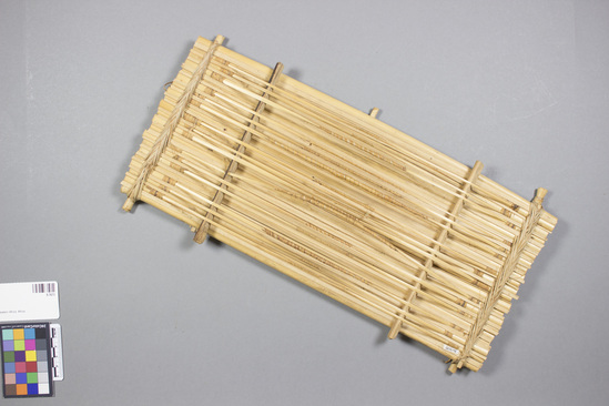 Hearst Museum object 2 of 2 titled Zither, accession number 5-7673, described as Zither, cane; a series of tied tules with stretched reeds which when plucked create a sounds. Length 43 cm; width 15 cm