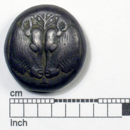 Hearst Museum object titled Coin: billon stater, accession number 8-5574, described as Coin; Billon; stater; Greek. 10.75 grams, 18.6 mm. 550-440 BC. Myilene, Greece. Obverse: two calves’ heads confronted, between them olive-tree. Reverse: rude incuse square.