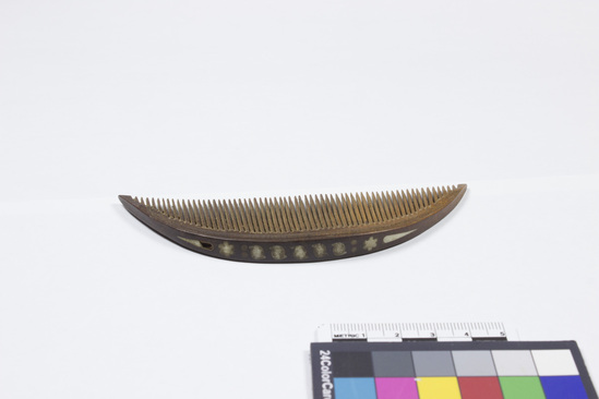 Hearst Museum object titled Comb, accession number 11-1660, described as Circular wooden comb, with white shell inlay.