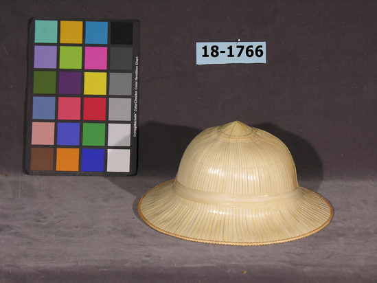 Hearst Museum object titled Hat, accession number 18-1766, described as Pith helmet made of strips of palm frond over a caned foundation with interior band and chin strap. Palm strips hand sewn to foundation.