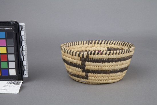 Hearst Museum object 2 of 2 titled Basket, accession number 2-68512, described as Round with flat base, circular stripes in dark brown on cream ground.  Bear grass warp, yucca weft, coiled.