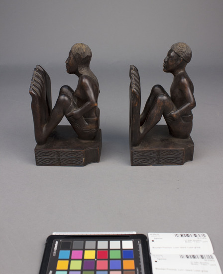 Hearst Museum object 3 of 8 titled Wood figurine, accession number 10-3141a,b, described as Bookends, wooden, male and female figures, 27 centimeters by 10 centimeters