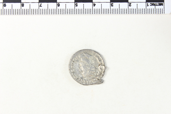 Hearst Museum object 5 of 8 titled Coin: billon antoninianus, accession number 8-4376, described as Coin; Billon; Antoninianus; Roman. 3.15 grams, 23 mm. Gallienus, 253-254 AD. Obverse: IMP C P LIC GALLIEVS AVG, bust r. radiate. Reverse: VIRTVS AVGG, soldier standing l.