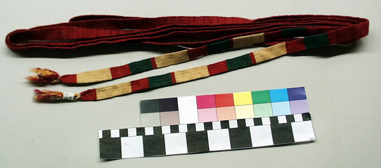 Hearst Museum object titled Cinta, accession number 3-86, described as Woman’s headband or cinta; twilled wool and cotton; red with green and off-white portions; approximately 3 m 26 cm, 1.6 cm wide