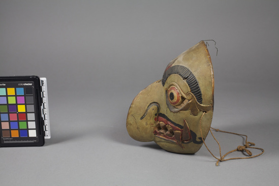 Hearst Museum object 4 of 4 titled Mask, accession number 18-1193, described as Mask, wood, carved and painted; large hook nose and pointed teeth; green, gold, black and red. Used in dance. 18.5 cm.