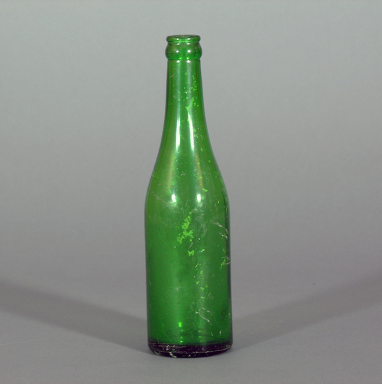 Hearst Museum object titled Bottle, accession number 1-245646, described as Whole green glass bottle with numbering / lettering. "103" near base. Numbers on base. Visible vertical seam.