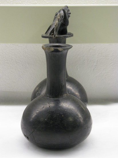 Hearst Museum object 17 of 27 titled Whistling jar, accession number 4-5394, described as Black whistling jar: joined globose bodies, long necks with connecting handle incomplete; figures of men and fishes on top of one spout. Mended.