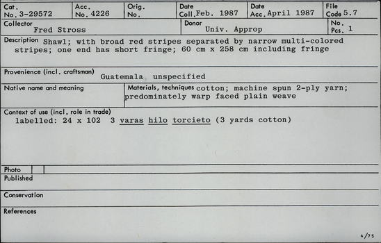 Documentation associated with Hearst Museum object titled Shawl, accession number 3-29572, described as Shawl; with broad red stripes separated by narrow multi-colored stripes; one end has short fringe; 60 cm x 258 cm including fringe.  Materials, techniques; cotton; machine spun 2-ply yarn; predominately warp face plain weave. Context of use: labelled 24 x 102 3 varas hilo torcieto ( 3 yards cotton).