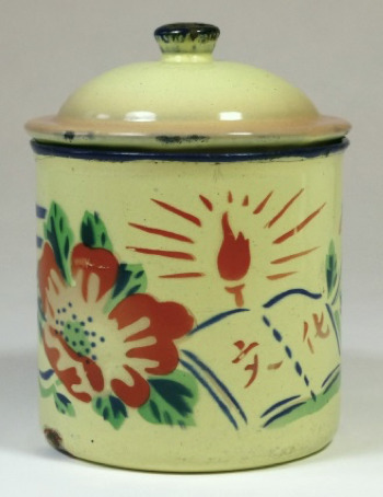 Hearst Museum object titled Mug with lid, accession number 9-23909a,b, described as Enamel mug with lid. The yellow ground is stenciled with an image of a large red flower surrounded by green leaves. On the right there is a radiating red torch on the background and a book on the forefront marked “Culture (文化wenhua). Cobalt blue bowstring decorates the rim. The handle and finial is partially decorated in the same color. Pink pigment is sprayed onto the edge of the lid. The mug may have been made during the One-hundred Flowers Bloom Campaign (百花齊放運動Baihua qifang yundong). 70 RMB