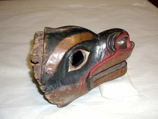 Hearst Museum object 7 of 9 titled Mask, accession number 2-10870, described as Bear head mask, decorated with strips of copper; dark brown glass eyes; wood painted black (?), red and white. Had fur cap attached, now long since destroyed by moths.