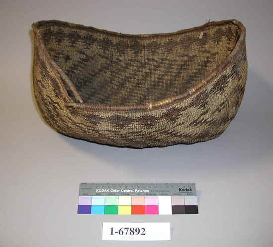 Hearst Museum object 1 of 2 titled Basket, accession number 1-67892, described as Twined basket, oval. Per Ralph Shanks:  Plain twined.  Start is plain twined over two warps.  Reinforced rim made of wrapped warp sticks.  Rim has damage in several places.  Conifer root weft with beargrass overlay.  Black designs are probably maidenhair fern.  Designs include a band of designs around rim, and then diagonal parallelograms.