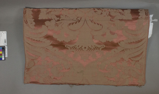 Hearst Museum object titled Textile, accession number 2-62510, described as Strip; cotton, silk?, damask, red ground and light brown design, floral and leaf motives, Jacquard looms