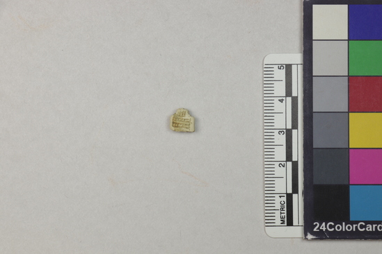 Hearst Museum object 2 of 6 titled Fragment, accession number 5-13186, described as Fragment, heavily eroded, cross-shaped with checkered design, 1 cm square.