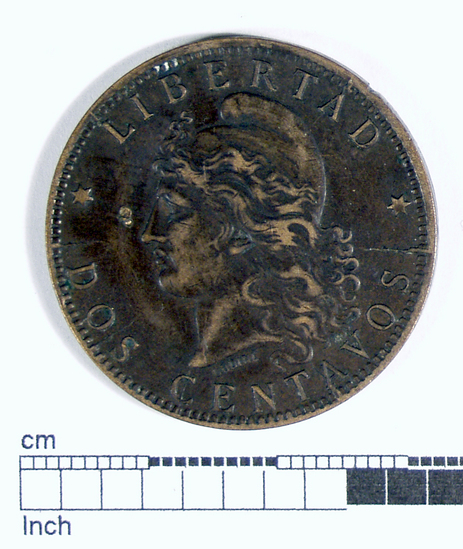 Hearst Museum object titled Coin: bronze 2 centavo, accession number 16-18342, described as Obverse: Coin, Bronze. Argentina. Female head with revolutionary bonnet. Inscribed ‘LIBERTAD’ over head, ‘DOS CENTAVOS’ below. Reverse: Hands and bonnet awthin oval of flags. Inscribed ‘REPUBLICA ARGENTINA - 1891’. Content: Bronze. Denomination: 2 centavos Weight: 9.97 g. Condition: Fine.