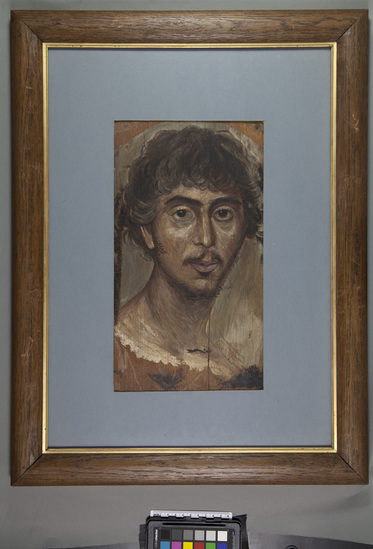 Hearst Museum object titled Mummy portrait (reproduction), accession number 5-375, described as Copy of Greek mummy portrait from the Fayum Egypt. Original painted in the 3rd century Originals discovered by Flinders Petrie are in National Gallery London. Painted in wax colors applied with brush to cestrum. Copies by Eleanor Harrison Supplee