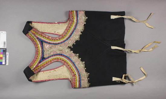 Hearst Museum object titled Vest, accession number 7-3243, described as vest; black wool felt w/velvet, metal, varicolored embroidery bands; metal-wrapped yarns , strips, discs, silk embroidery; linen lining. part of set 7-3241--3244. 16" long