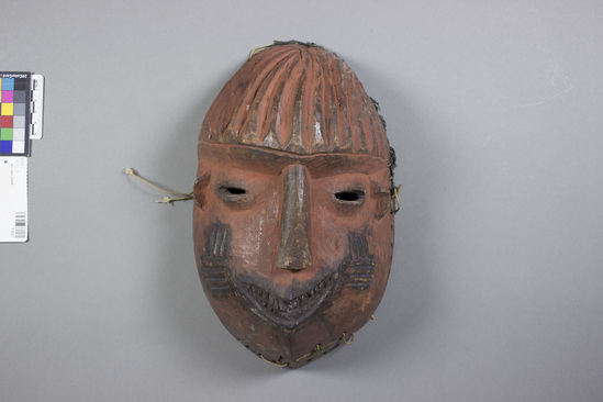 Hearst Museum object titled Mask, accession number 5-6267, described as Mask; wood; ovoid; incised indigo vertical and horizontal lines on cheeks; indigo mouth. Height 30 cm. Width 12.5 cm.