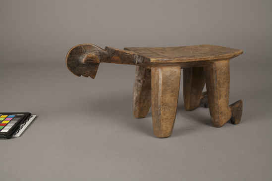 Hearst Museum object 3 of 3 titled Stool (seating furniture), accession number 5-11705, described as Stool; carved, anthropomorphic (kneeling figure), linear design incised on seat, light brown in color.