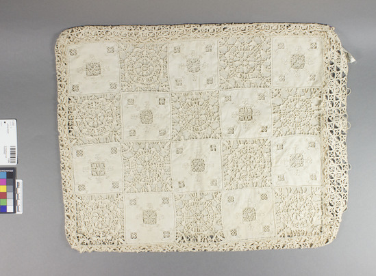 Hearst Museum object titled Pillow cover, accession number 7-3292, described as Pillow cover; plain linen; reticello lace front; designs of alternating squares of open medallions and squares mainly of uncut textile; plain weave back. According to Kaethe Kliot (1977) this is reticella with fine bobbin lace edging