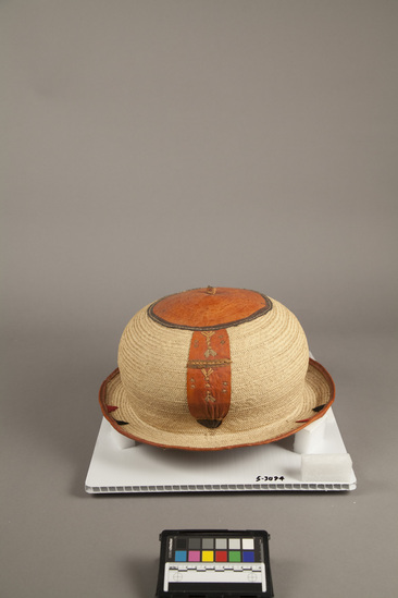 Hearst Museum object titled Basketry hat, accession number 5-3094, described as Basketry hat; Malfa; fiber, large dome shape; red leather trim with same chin strap.