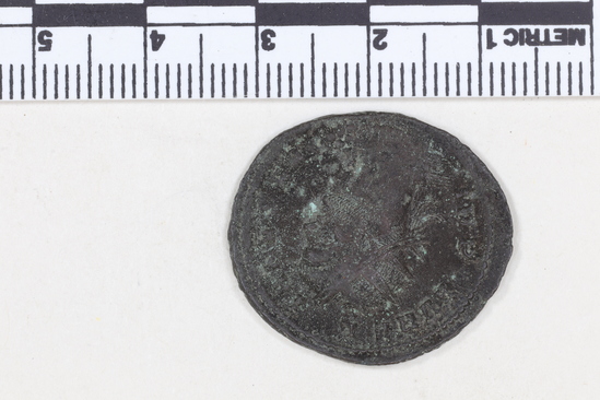 Hearst Museum object 6 of 8 titled Coin: billon antoninianus, accession number 8-4067, described as Coin; Billon; Antoninianus; Roman. 4.30 grams, 26 mm. Aurelian, 270-275 AD. Rome, Italy. Obverse: IMP C AVRELIANVS, Bust r. radiate. Reverse: ORIENS AVG, Sol l., between two captives, in exergue P M