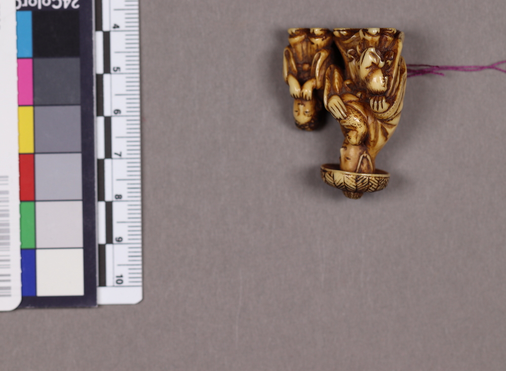 Hearst Museum object titled Netsuke, accession number 9-7650, described as Netsuke of a woman in a great hat, with a baby in her arms, and two other children, walking at each side. Depiction of Tokiwa Gozen.