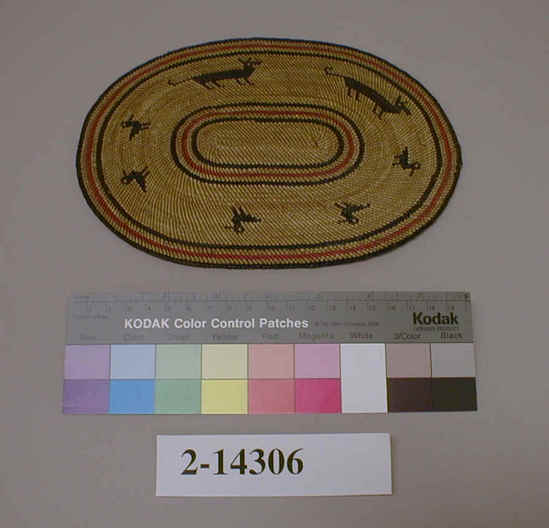 Hearst Museum object titled Mat, accession number 2-14306, described as Spiral lattice weave; black and red lines around edge and middle; two animals and five birds between center and border, all in black.  Oval-shaped.