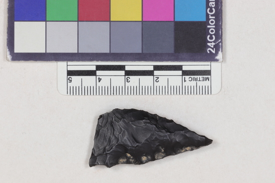 Hearst Museum object 1 of 2 titled Projectile point fragment, accession number 16-14267, described as Projectile point; obsidian; triangular; weight: 6.79 grams; length: 4.06 cm; width: 2.05 cm; depth: 0.75 cm; convex sides; broken.