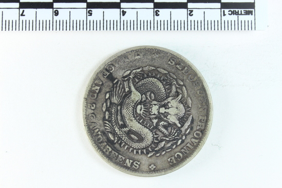 Hearst Museum object titled Coin: guang xu yuan bao, accession number 9-6017, described as Coin; Ag; 1 dollar; (7 mace and 2 candareens). Obverse: Dragon. Reverse: Chinese script; 1909.
