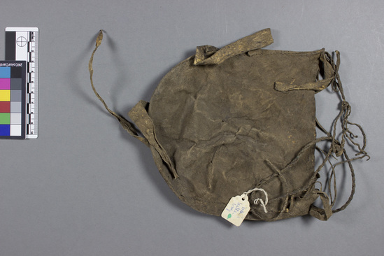 Hearst Museum object titled Bag, accession number 5-4117, described as Man's leather bag; pendant strips of leather around sides; handle of 2 ply leather cord; 7.0 cm long.