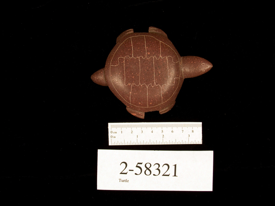 Hearst Museum object titled Turtle, accession number 2-58321, described as Carved catlinite; signed "Winona;"  CONSERVATION:  head has been broken off and repaired with glue.