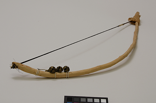 Hearst Museum object 4 of 4 titled Musical bow, accession number 9-10950, described as bow for stringed musical instrument; wood, horsehair, bells, cloth; Length 53 cm.