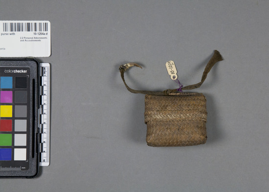 Hearst Museum object titled Small woven purse with metal inside, accession number 10-1204a-d, described as a,b) Flint and steel basket; plaited rattan; telescope type; thong wit h claw on top; cotton wadding tinder; 2 5/8 x 2” closed c) piece of steel d) Stone, probably chalcedony