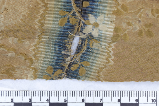 Hearst Museum object 19 of 49 titled Icon, accession number 7-3541, described as Icon of “Our lady of Vladmir”; Virgin and Child in tempera and gesso on wood; gilded silver basma; cloisonne halo with cloisonne collar pendant; halo has glass and amber (?) ornamentation; Virgin’s face damaged; height 30.2 cm, width 26 cm.