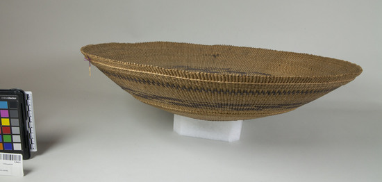 Hearst Museum object 3 of 3 titled Tray, accession number 1-28431, described as Twined basket tray.  2 brown bands in design.