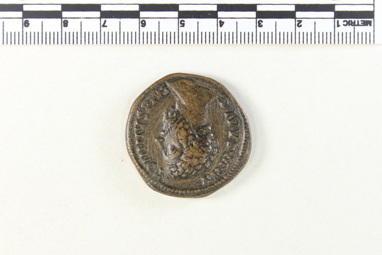 Hearst Museum object 2 of 8 titled Coin: æ sestertius, accession number 8-4879, described as Coin; AE; Sestertius; Roman. 32 mm. Commodus, 180 AD. Rome, Italy. Obverse: DIVVS M ANTONINVS PIVS, bust of Divus Marcus r.. Reverse: CON SE CRATIO, funeral pyre with Marcus Aurelius in quadriga on top; in field, S C.