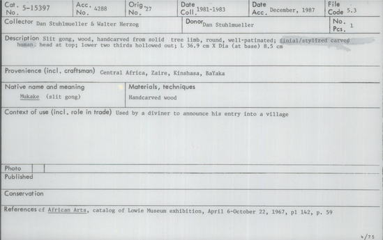 Documentation associated with Hearst Museum object titled Gong, accession number 5-15397, described as Slit gong, wood, hand carved from solid tree limb, round, well-patinated; finial/stylized carved human head at top; lower two thirds hollowed out. Length 36.9 cm. Diameter (at base) 8.5 cm. Used by a diviner to announce his entry into a village.