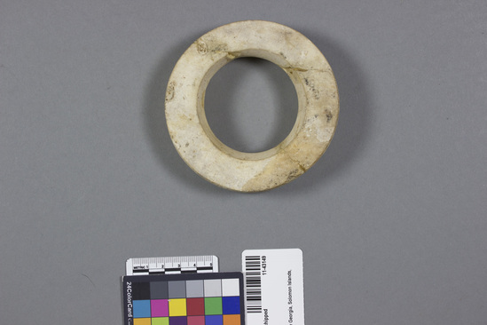 Hearst Museum object titled Ring, clamshell, chipped, accession number 11-43149, described as Ring. Heavy clamshell, chipped, broken and glued in three places. diam. - 10.5 cm. Collector states that specimen is a "dollar" used solely in exchange.