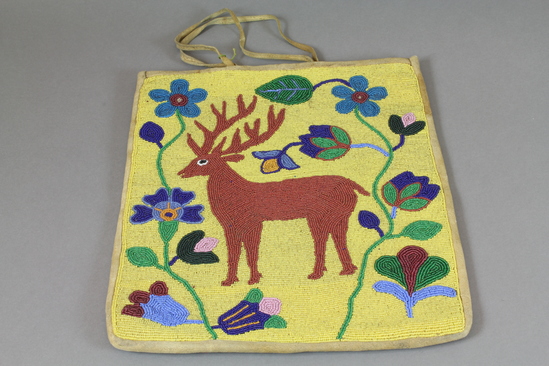 Hearst Museum object titled Bag, accession number 2-37065, described as Made of beaded deerskin; yellow glass "seed" bead ground; brown deer motif with surrounding floral design. Thong handles.