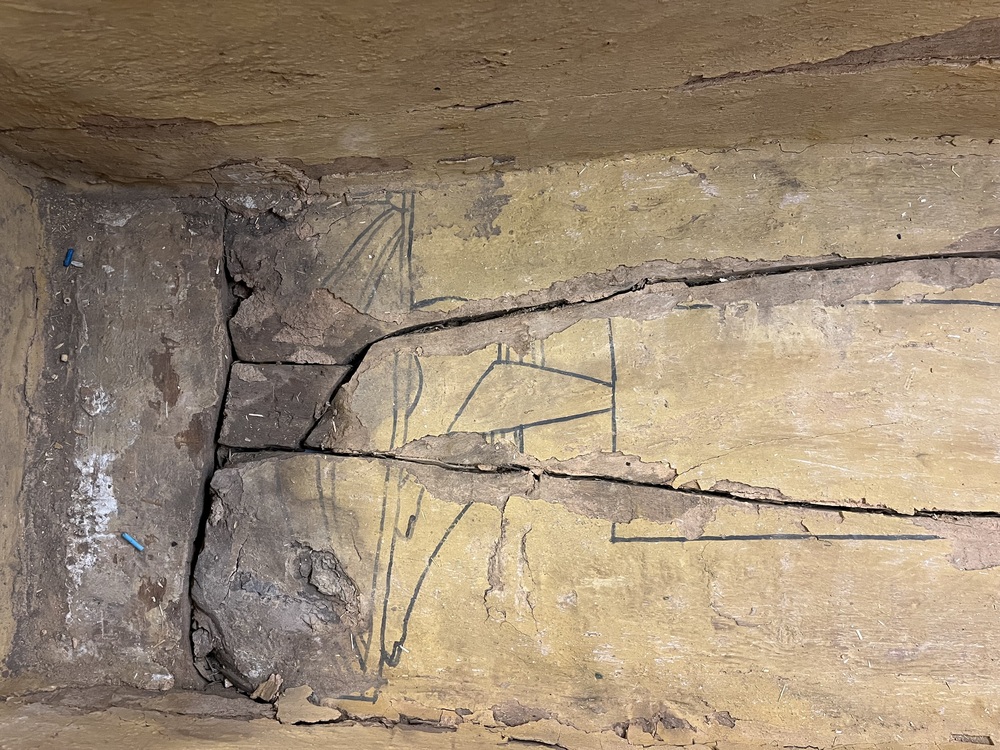 Hearst Museum object 78 of 167 titled Coffin, accession number 6-19912, described as Wooden anthropoid coffin. Inscription running down center of lid. Determined by Kea Johnston to probably be the outer coffin of Iwefaa (6-19928, 12-11039). According to Kea Johnston, "This coffin belonged to a man named Iwefaa, whose name is inserted in the middle of the spells written in the two columns on the front. This coffin is likely the outer coffin for PAHMA 6-19928 based on the similarity of the owner's name, unusual costume, and the paleography of the inscription. Both coffins were purchased on the antiquities market by George Reisner for Phoebe A Hearst. However, stylistically, they are very similar to a set of coffins known to have come from the site of Akhmim, which was excavated in the 1880s by Gaston Maspero, and which has heavily looted for the antiquities market during this decade." "The pectoral vignette between the text and the collar shows the deceased standing before squatting baboon and is the source of our logo. The hieroglyph for 'sky' is above their heads, and the side borders are formed by a pyramid and the symbol for the West.