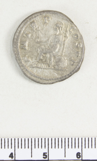 Hearst Museum object 6 of 8 titled Coin: billon denarius, accession number 8-4355, described as Coin; AR; Billon Antoninianus; Roman. 4.66 grams, 23 mm. Elagabalus, 218 AD. Rome, Italy. Obverse: IMP CAES M AVR ANTONINVS AVG, bust r. radiate. Reverse: P M TR P COS P P, Roma seated l.