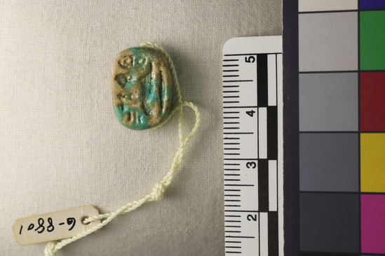 Hearst Museum object 8 of 19 titled Amulet, accession number 6-8801, described as Oval plate amulet, blue glaze partly gone