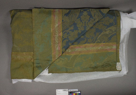 Hearst Museum object titled Textile sample, accession number 2-62464, described as Yardage; cotton, rayon, damask, warp striped, varicolored, floral and leaf motives, similar design to 545, Jacquard looms