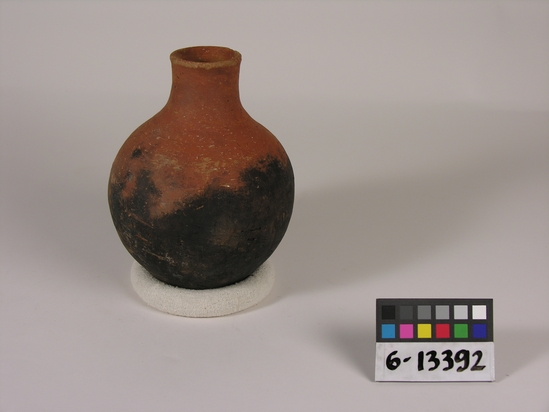 Hearst Museum object titled Bottle, accession number 6-13392, described as Pottery: bottle, maroon, blackened; least diameter 5 cm, greatest diameter 13 cm, height 17 cm.